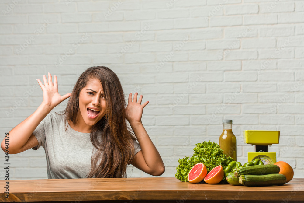 Concept of diet. Portrait of a healthy young latin woman crazy and desperate, screaming out of control, funny lunatic expressing freedom and wild Concept of diet. Portrait of a healthy young latin woman crazy and desperate, screaming out of control, funny lunatic expressing freedom and wild