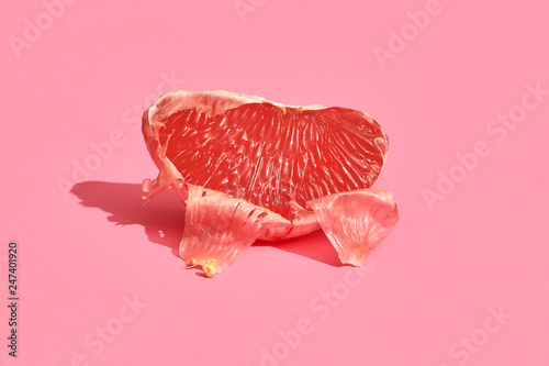 Slika na platnu Half of grapefruit citrus fruit isolated on pink