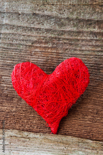 Red decoration heart against wooden background