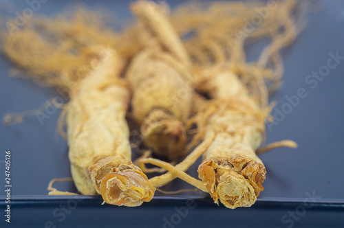 Ginseng root on the black plate photo