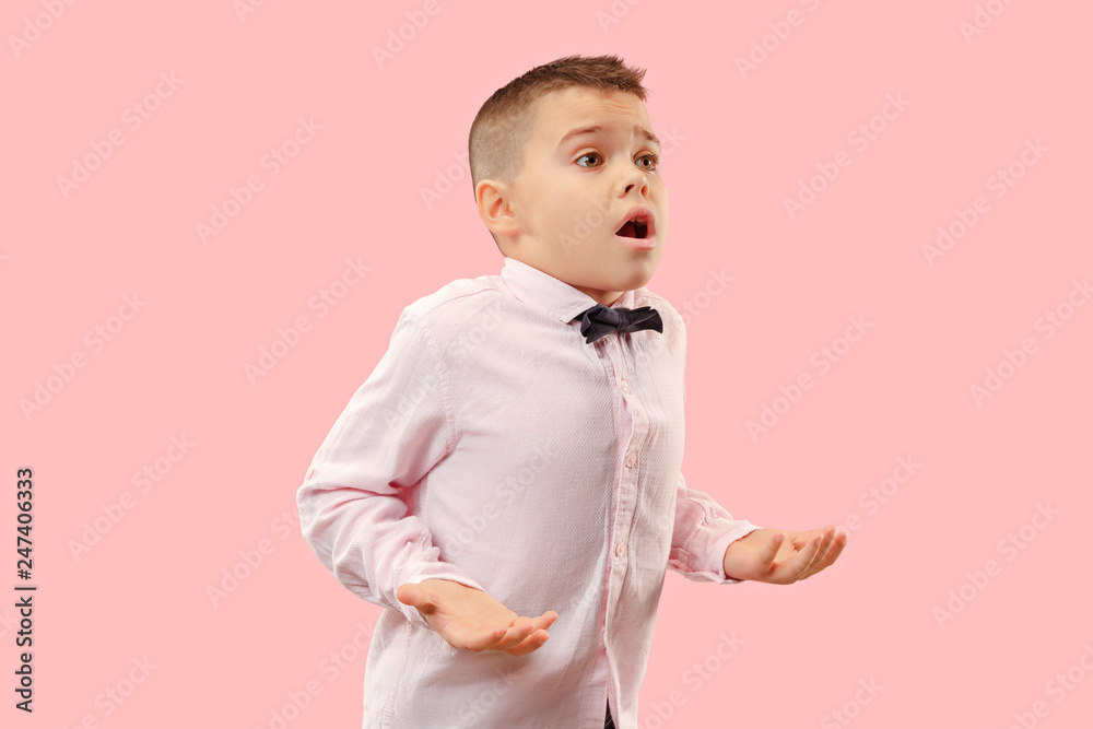 Wow. Attractive male half-length front portrait on pink studio backgroud. Young emotional surprised teen boy standing with open mouth. Human emotions, facial expression concept. Trendy colors Wow. Attractive male half-length front portrait on pink studio backgroud. Young emotional surprised teen boy standing with open mouth. Human emotions, facial expression concept. Trendy colors