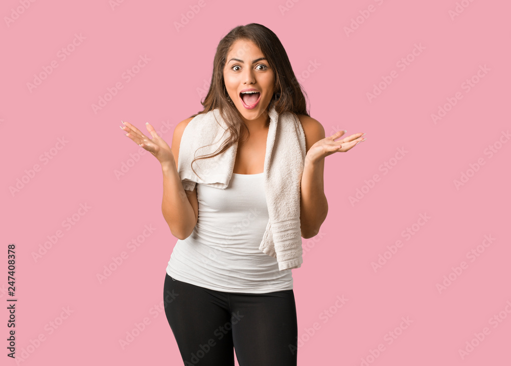 Full body young fitness curvy woman celebrating a victory or success Full body young fitness curvy woman celebrating a victory or success