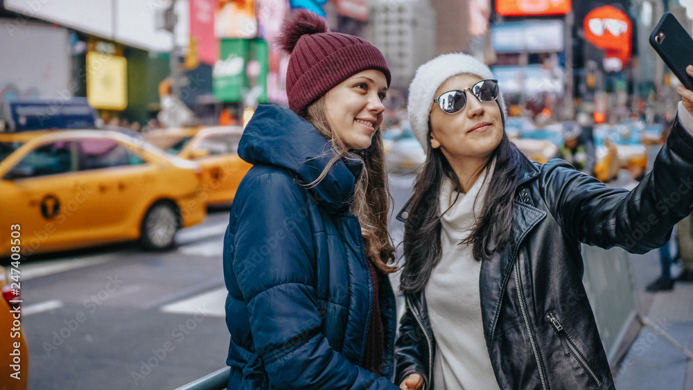 Two friends enjoy their vacation trip to New York
