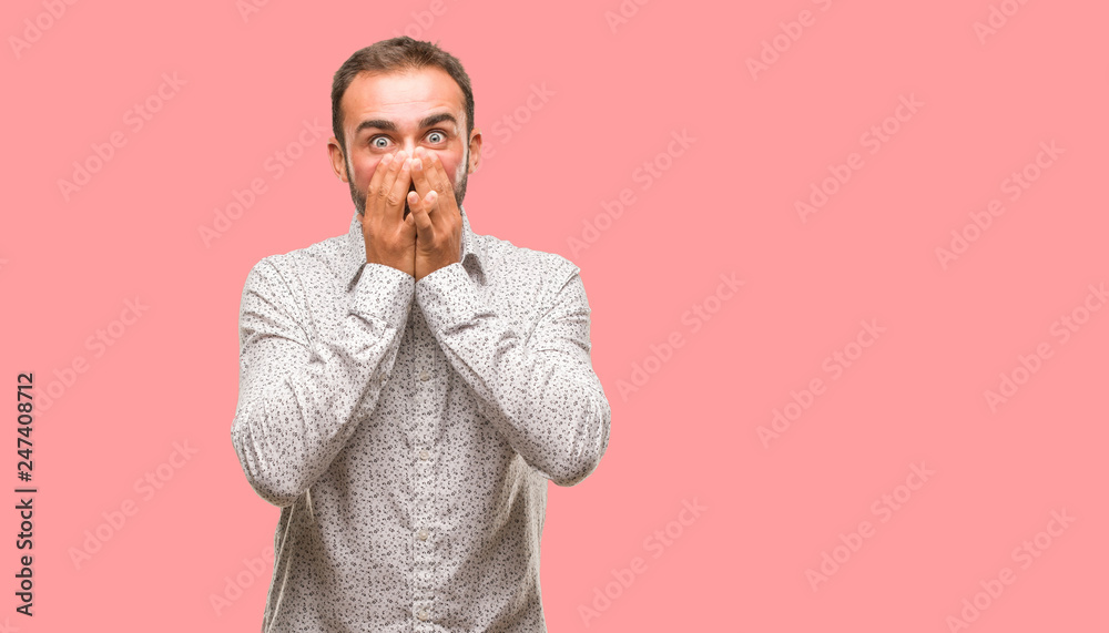 Fototapeta premium Caucasian man on grey brackground very scared and afraid hidden