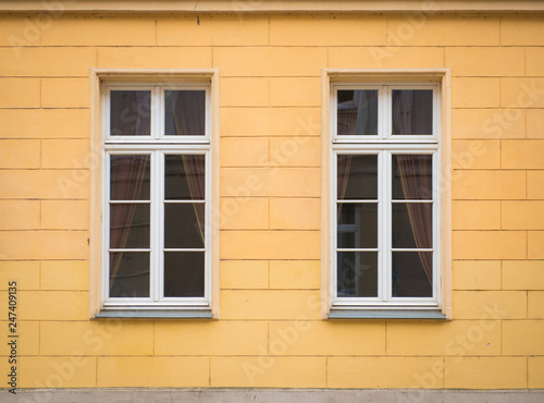 White window on brick yellow wall