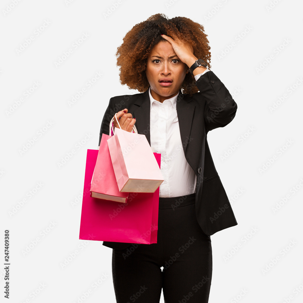 Young black woman holding shopping bags tired and very sleepy Young black woman holding shopping bags tired and very sleepy