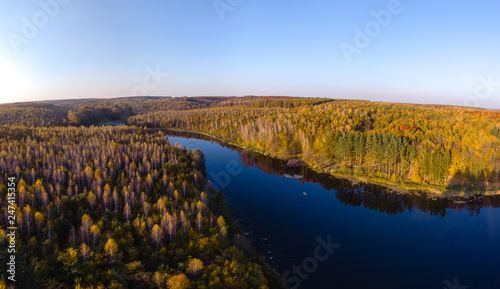 beautiful view from the drone to the lake in the forest  autumn day  multicolor trees  bright. outdoor recreation concept  in the countryside  barbecue fishing and camping