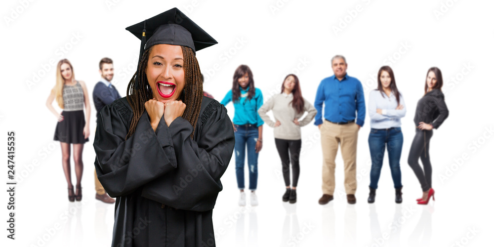 Young graduated black woman wearing braids very happy and excited, raising arms, celebrating a victory or success, winning the lottery