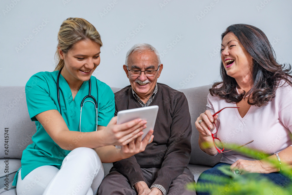 Home health care worker and an elderly couple Home health care worker and an elderly couple