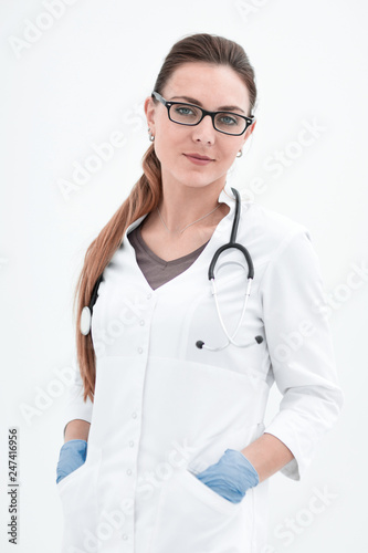 portrait of a serious woman doctor on a light background.