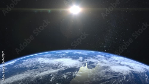 Earth from space. Stars twinkle. Flight over the Earth. 4K. Sunrise. The earth slowly rotates. Realistic atmosphere. 3D Volumetric clouds. The sun is in the frame. The camera 36mm moves forward. photo