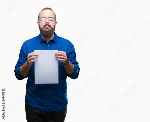 Young hipster man wearing glasses and holding blank paper over isolated background with a confident expression on smart face thinking serious