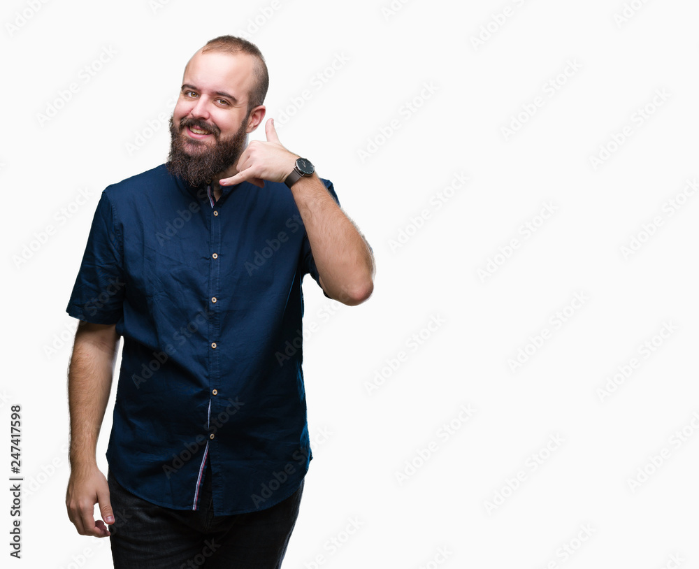 Young caucasian hipster man over isolated background smiling doing phone gesture with hand and fingers like talking on the telephone. Communicating concepts. Young caucasian hipster man over isolated background smiling doing phone gesture with hand and fingers like talking on the telephone. Communicating concepts.