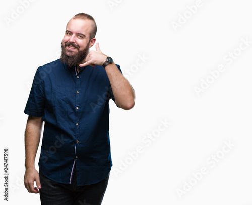 Young caucasian hipster man over isolated background smiling doing phone gesture with hand and fingers like talking on the telephone. Communicating concepts.