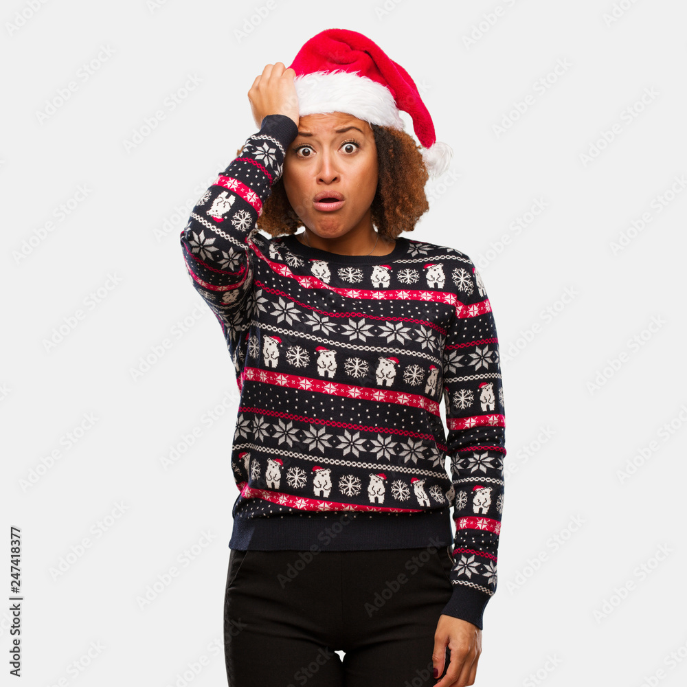 Young black woman in a trendy christmas sweater with print worried and overwhelmed Young black woman in a trendy christmas sweater with print worried and overwhelmed