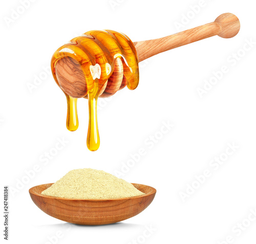 pollen in a bowl and dripping honey isolated on a white background
