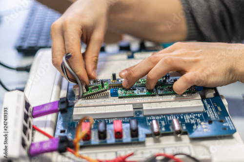 engineer hold circuit or silicon chip in his workplace b