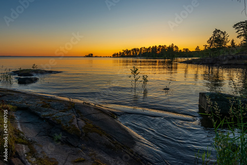 Bronze sunset and silence of the passing day. The wonderful island Valaam is located on Lake Lodozhskoye, Karelia. Balaam - a step to heaven photo