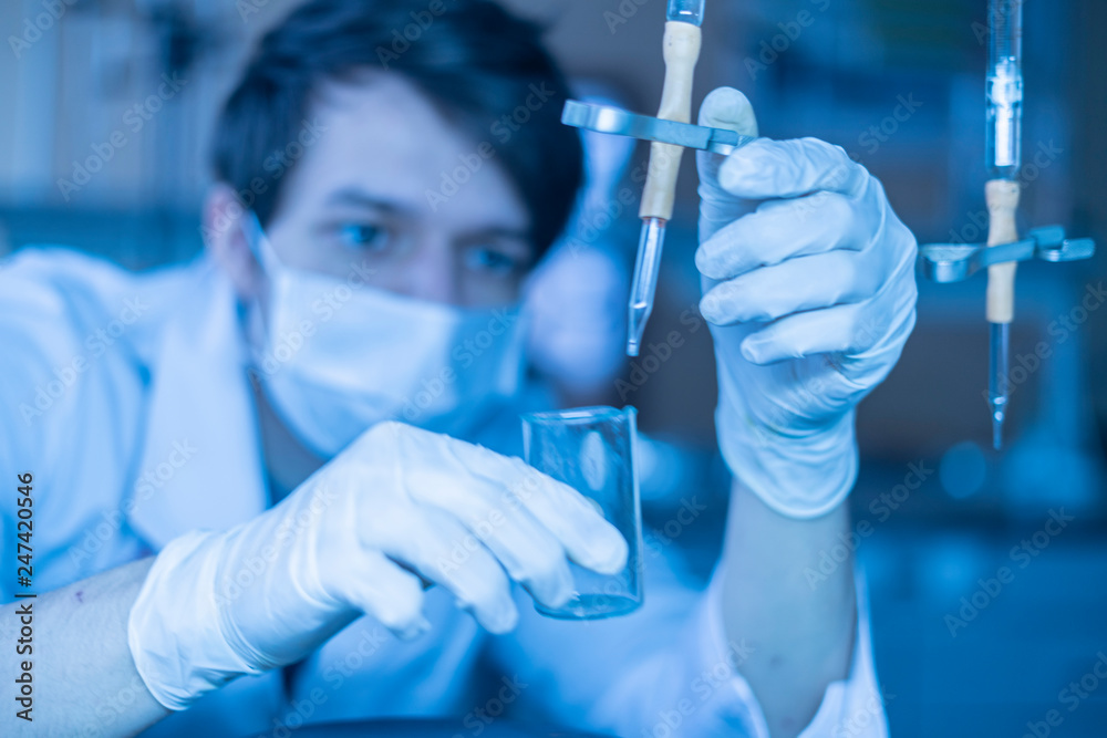 young student conduct chemical tests at school with glass flasks b young student conduct chemical tests at school with glass flasks b