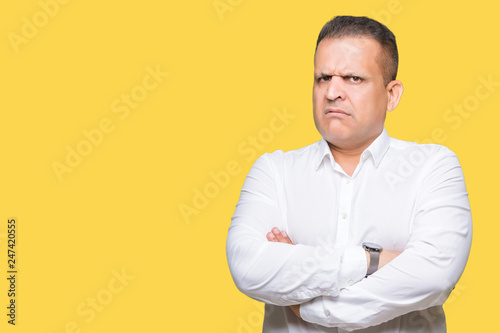Middle age arab elegant man over isolated background skeptic and nervous, disapproving expression on face with crossed arms. Negative person.