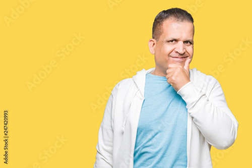 Middle age arab man wearing sweatshirt over isolated background looking confident at the camera with smile with crossed arms and hand raised on chin. Thinking positive.