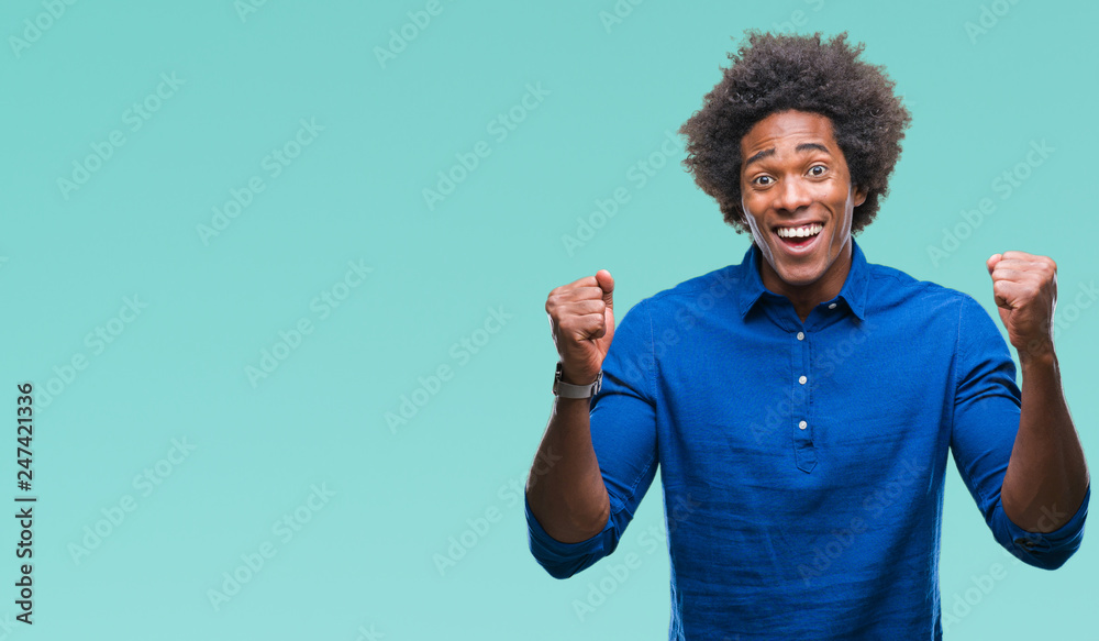 Afro american man over isolated background celebrating surprised and amazed for success with arms raised and open eyes. Winner concept. Afro american man over isolated background celebrating surprised and amazed for success with arms raised and open eyes. Winner concept.