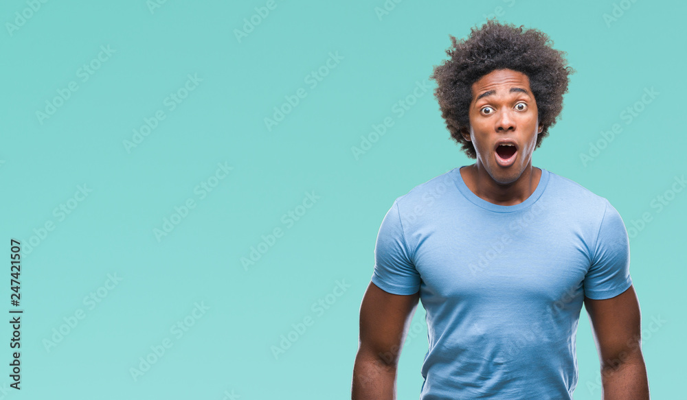 Afro american man over isolated background afraid and shocked with surprise expression, fear and excited face. Afro american man over isolated background afraid and shocked with surprise expression, fear and excited face.