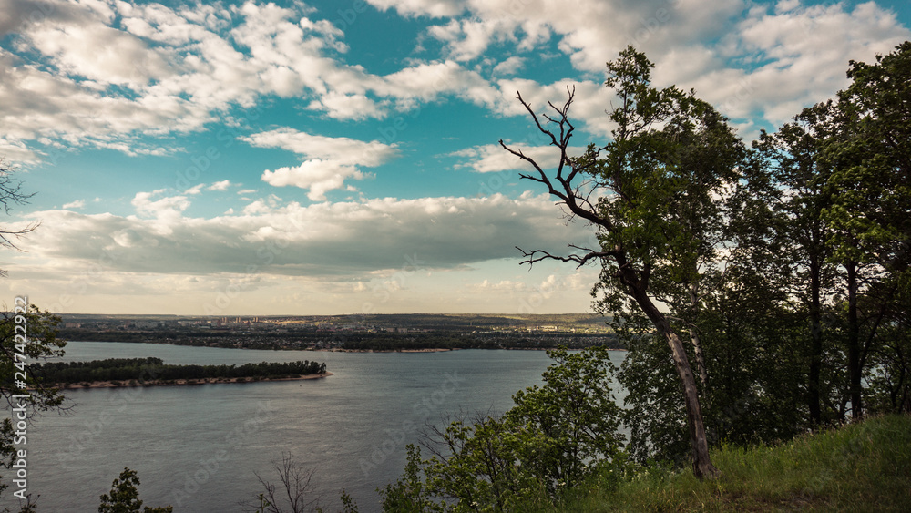 Beautiful summer landscape. Bright blue sky with clouds and the Volga river