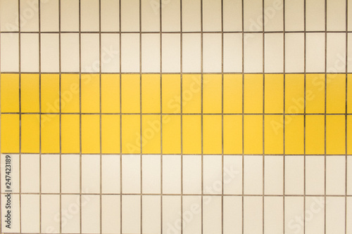 Yellow and white tiles in a subway station in Düsseldorf, Germany
