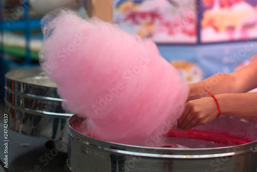 Girl makes pink cotton candy