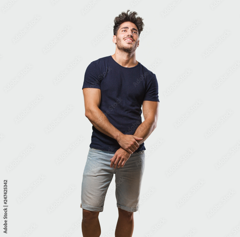 Fototapeta premium Young handsome man standing cheerful and with a big smile, confident, friendly and sincere, expressing positivity and success
