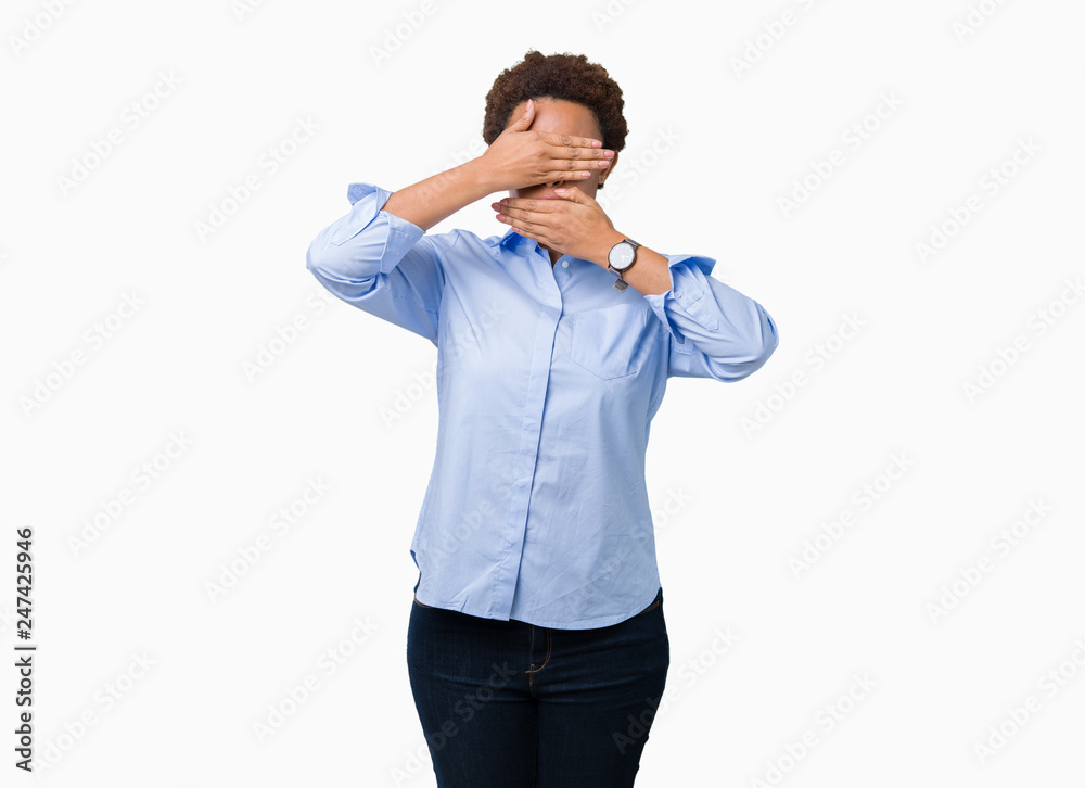 Young beautiful african american business woman over isolated background Covering eyes and mouth with hands, surprised and shocked. Hiding emotion Young beautiful african american business woman over isolated background Covering eyes and mouth with hands, surprised and shocked. Hiding emotion