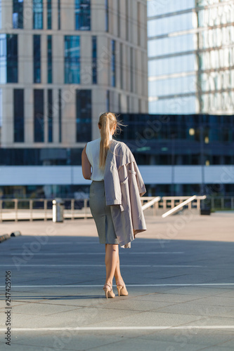 Portrait of a young successful business lady standing among the downtown © oleg_chumakov