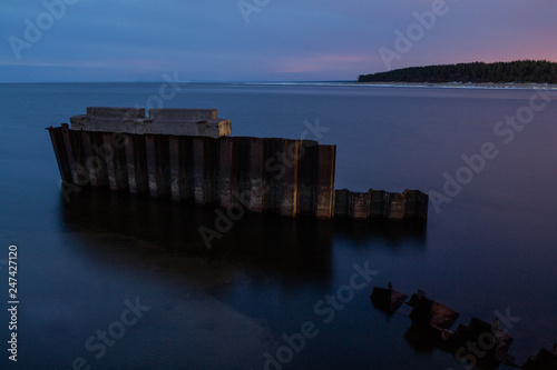 Embedded stones and harbor ruins in Narva-J  esuu. Rocky beach  peaceful sea and port. Harbour Ida-Viru County  Narva  Estonia. Baltic sea  Europe