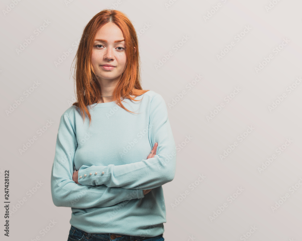 portrait of a pretty redhead girl crossed arms portrait of a pretty redhead girl crossed arms