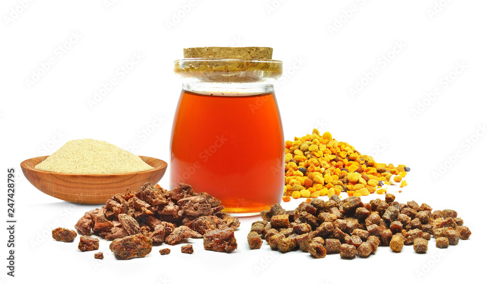 pollen, royal jelly and propolis in a bottle isolated on a white background pollen, royal jelly and propolis in a bottle isolated on a white background