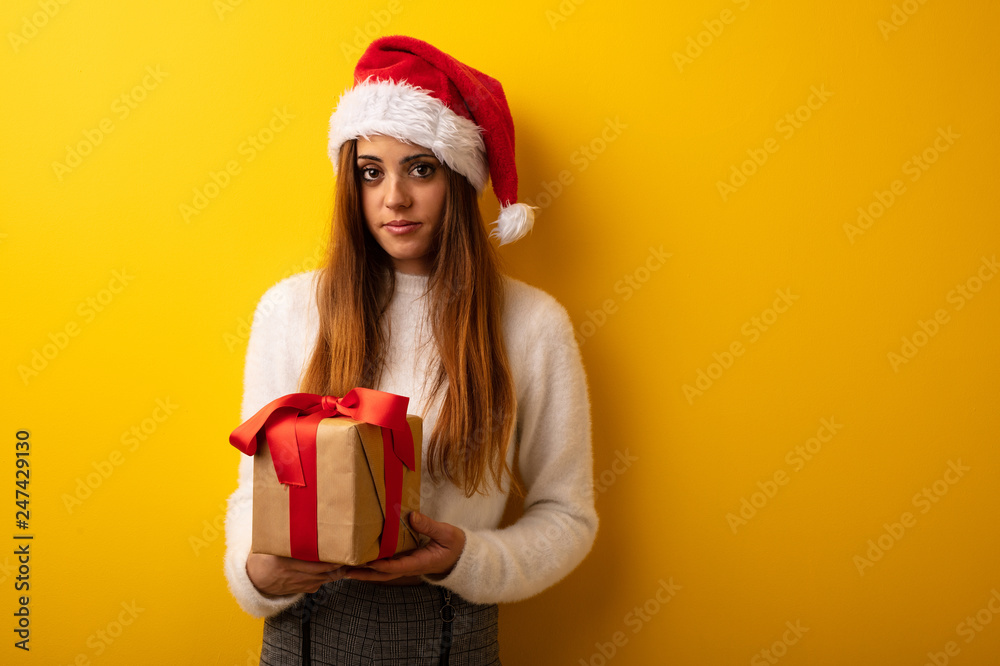 Young woman wearing santa hat celebrating christmas day Young woman wearing santa hat celebrating christmas day