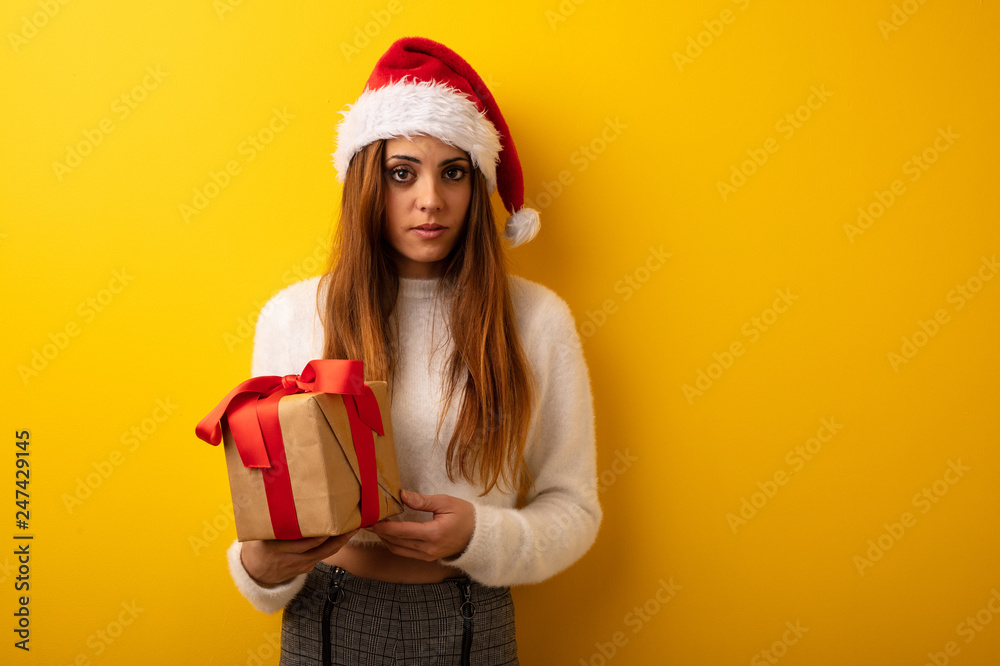 Young woman wearing santa hat celebrating christmas day Young woman wearing santa hat celebrating christmas day