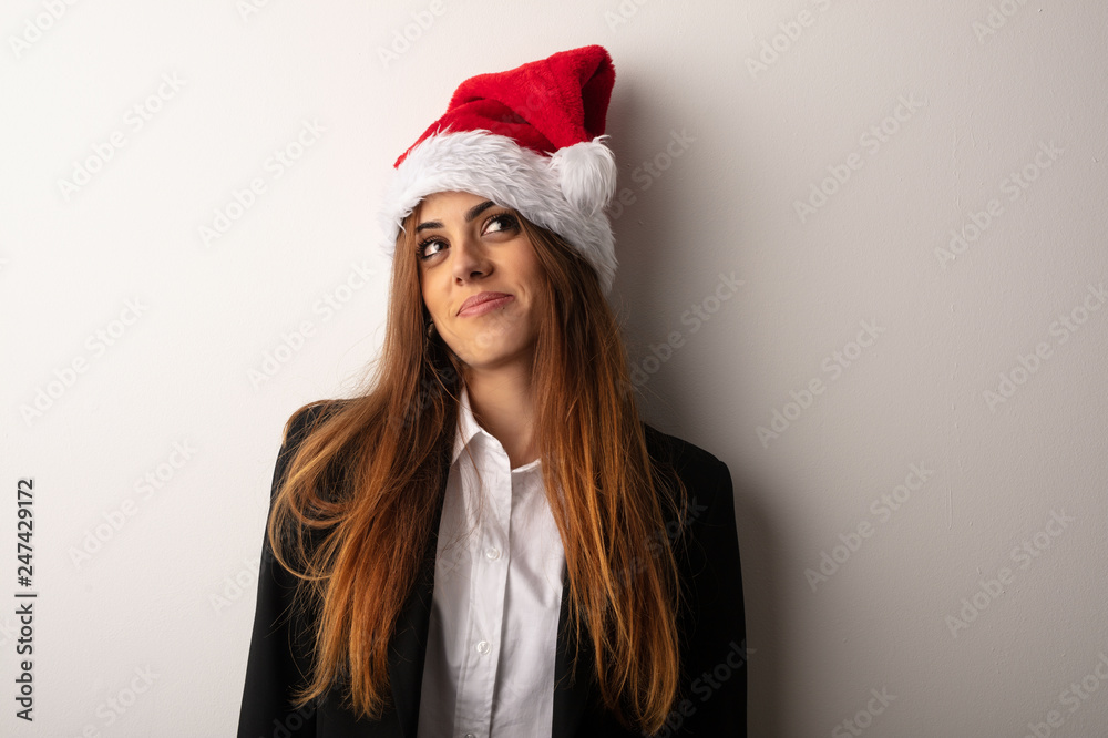 Young business woman wearing santa hat celebrating christmas day Young business woman wearing santa hat celebrating christmas day