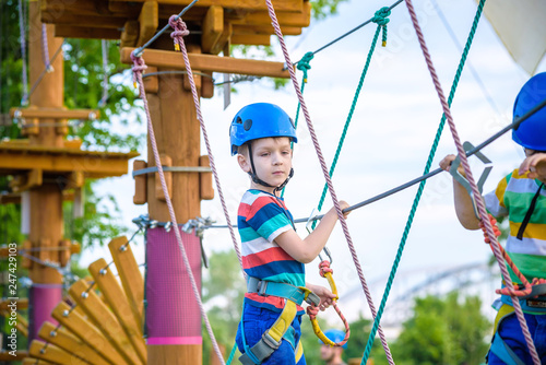 Young boy playing and having fun doing activities outdoors. Happiness and happy childhood concept