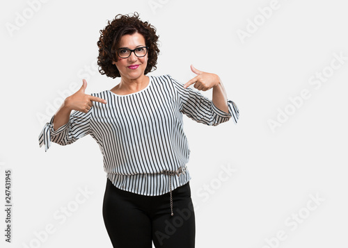Photography Middle aged woman proud and confident, pointing fingers, example to follow, conc