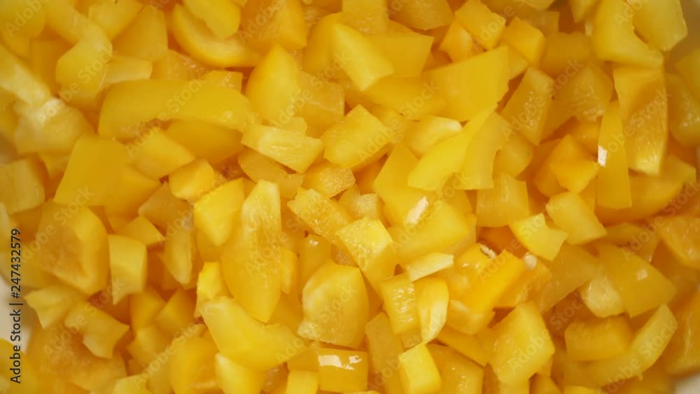 Close up sliced yellow pepper vegetable rotating. Healthy food. Top down view