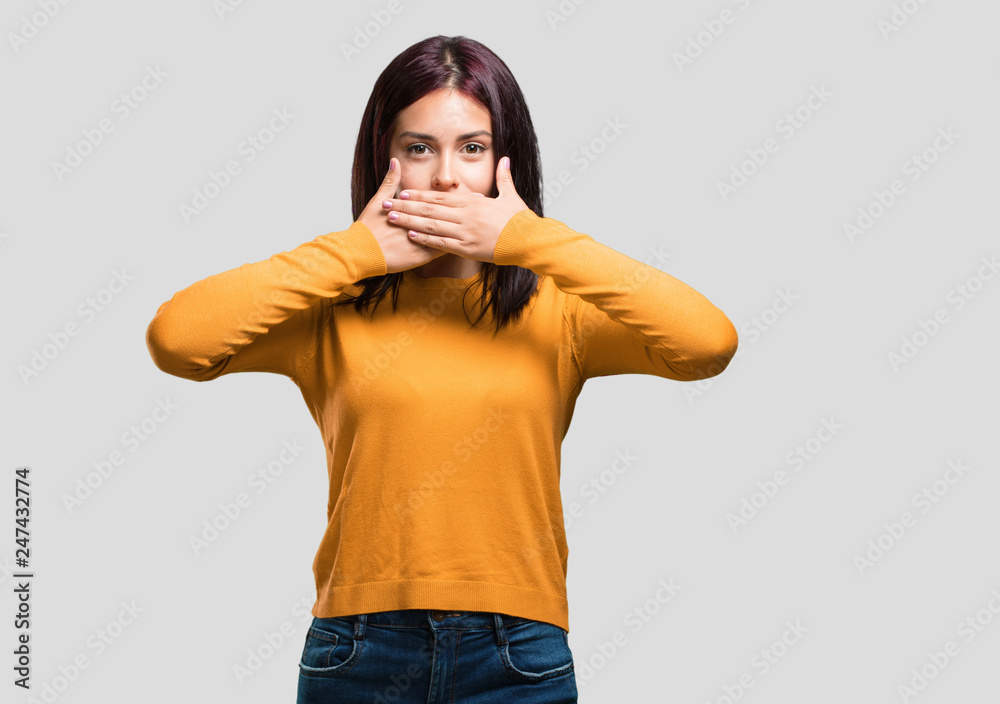 Young pretty woman covering mouth, symbol of silence and repression, trying not to say anything Young pretty woman covering mouth, symbol of silence and repression, trying not to say anything
