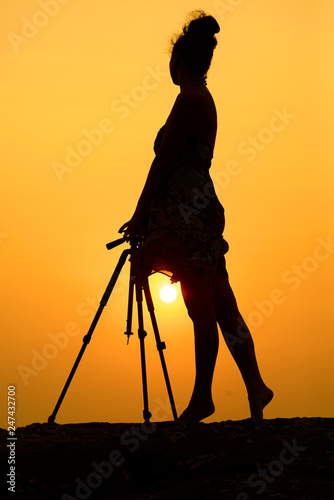 Photography Silhouette of a girl photographer on the ocean, Goa, India