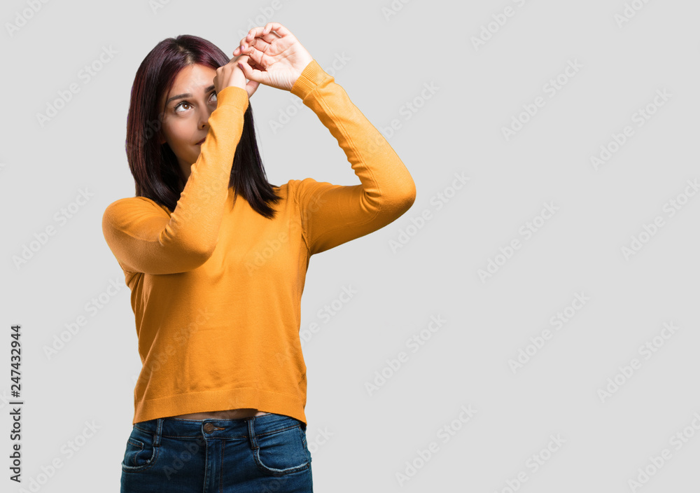 Young pretty woman looking through a gap, hiding and squinting Young pretty woman looking through a gap, hiding and squinting