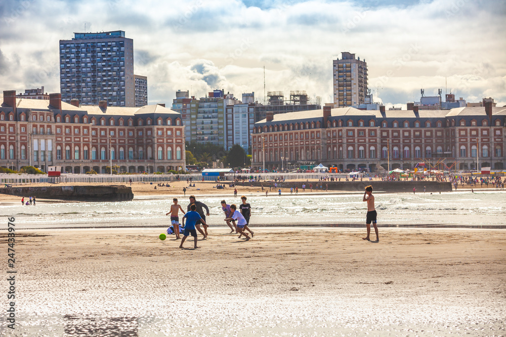 Mar Del Plata, Argentina - 26 Octubre, 2018: Children playing football on the shores of the Atlantic Ocean