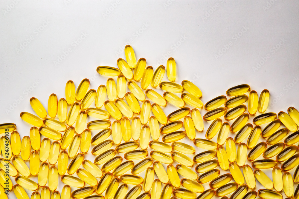 Obraz premium Omega-3 fish fat oil capsules on a white background.