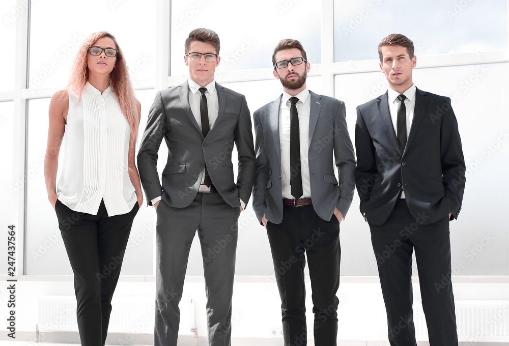 in full growth. business team standing in the office. in full growth. business team standing in the office.