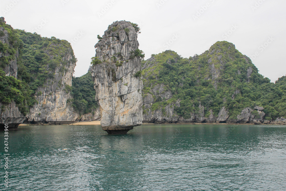 Stunning views of the quaint cliffs and the sea with turquoise water in the most famous place in Vietnam - Ha Long Bay. Stunning views of the quaint cliffs and the sea with turquoise water in the most famous place in Vietnam - Ha Long Bay.