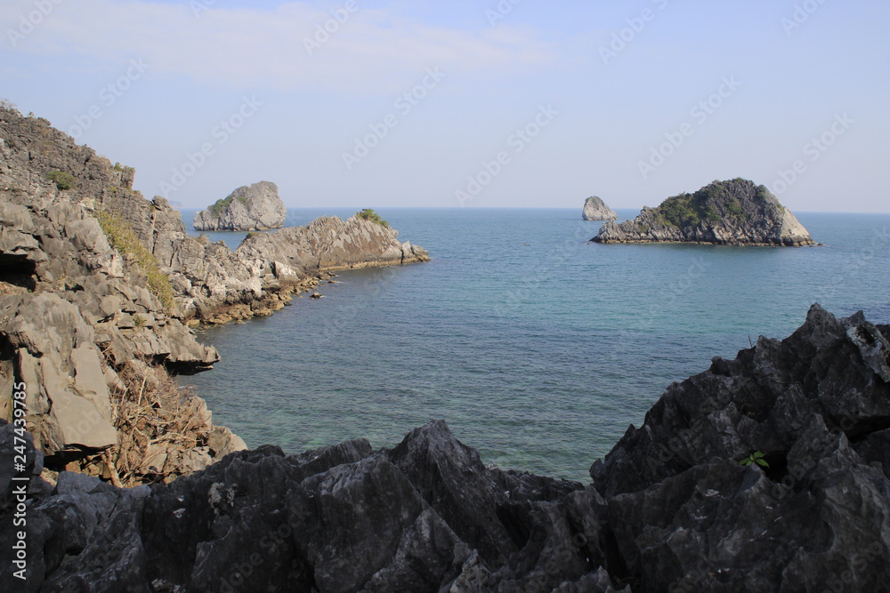 Stunning views of the quaint cliffs and the sea with turquoise water in the most famous place in Vietnam - Ha Long Bay. Stunning views of the quaint cliffs and the sea with turquoise water in the most famous place in Vietnam - Ha Long Bay.